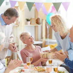 Radosne imieniny Ireny! Goście wręczają prezent, a solenizantka uśmiecha się wzruszona.