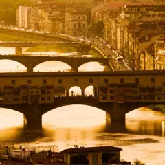 Florencja 18 maja. Złote światło zalewa Ponte Vecchio i rzekę Arno, tworząc malowniczy widok miasta.